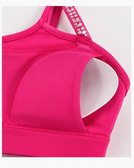 Detail of underarm cutout and strap construction in hot pink